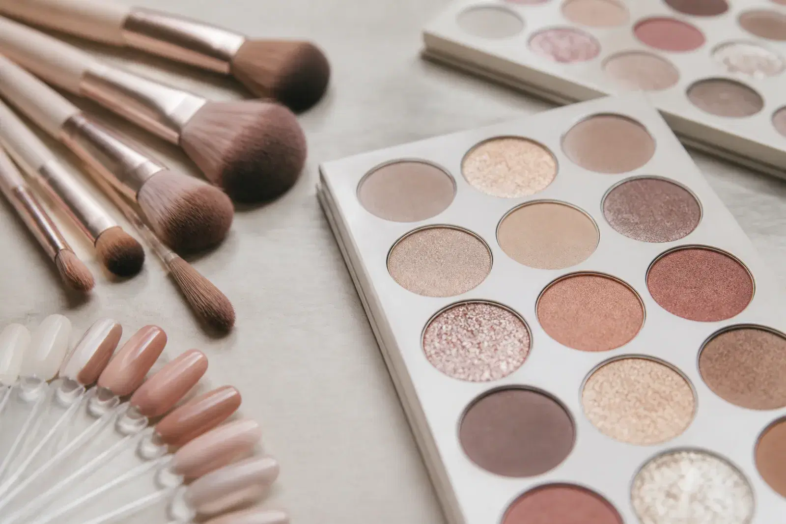 Soft-focus makeup brushes, nail swatches, and palettes for private access form